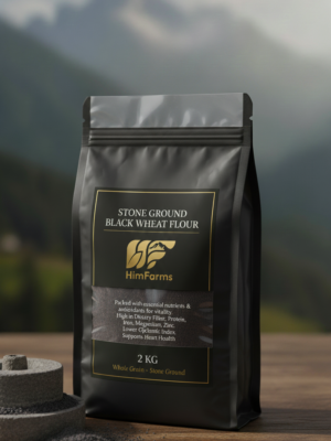 A close-up of dark, rich Himalayan Black Wheat flour in a rustic wooden bowl, with a small pile of black wheat grains beside it. The scene suggests natural, authentic produce.