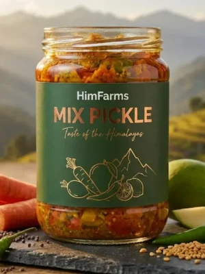 A close-up of a glass jar filled with HimFarms Mix Pickle, featuring chunks of mango, carrot, and green chili in rich oil. The jar has a premium matte forest-green label with gold foil typography and line-art illustrations of vegetables. It sits on a slate coaster surrounded by fresh raw ingredients—sliced carrots, green mangoes, and chilies—against a backdrop of sunlit Himalayan terraced fields.
